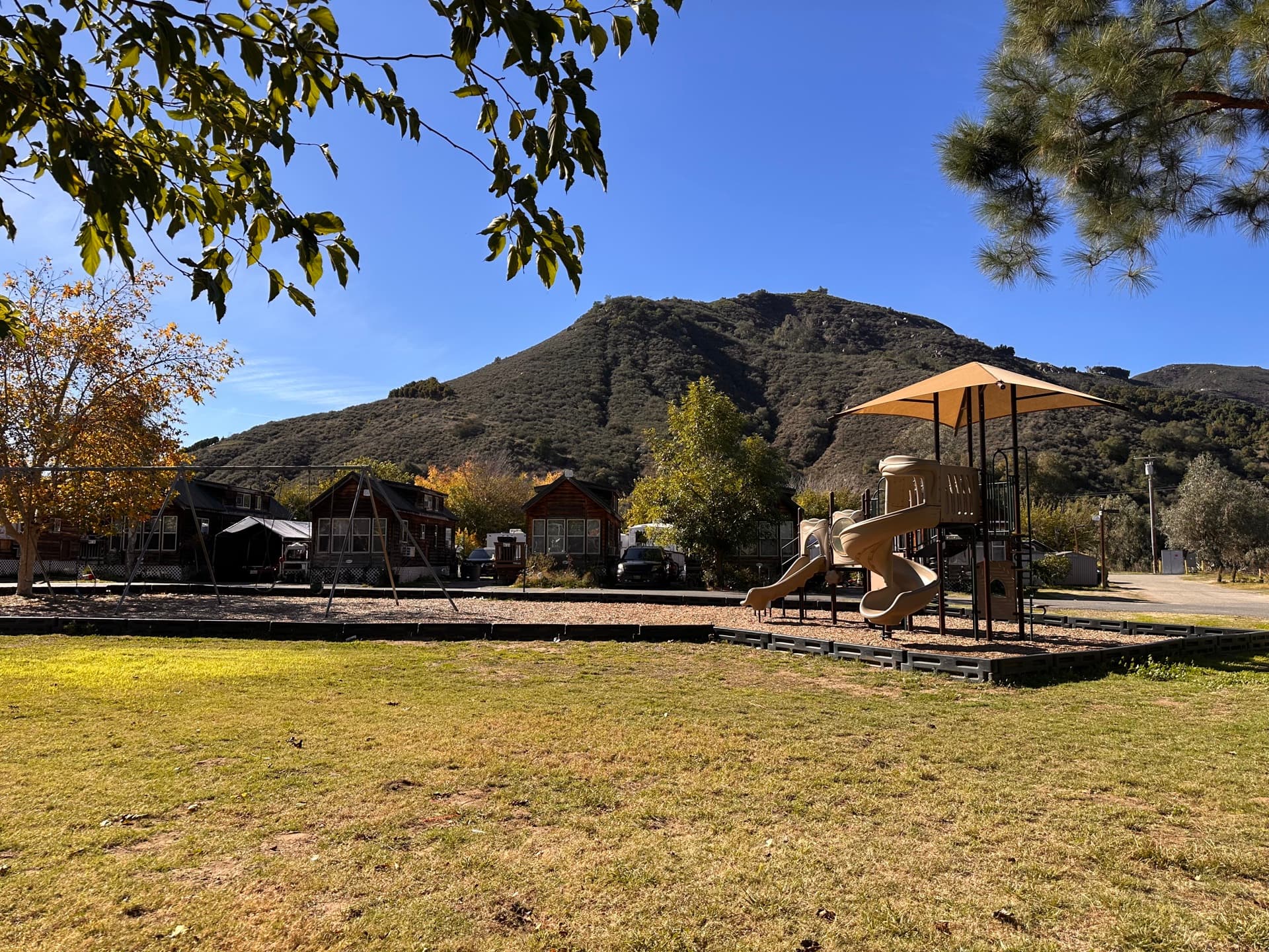 Playground with mountain backdrop at Rancho Corrido RV Resort